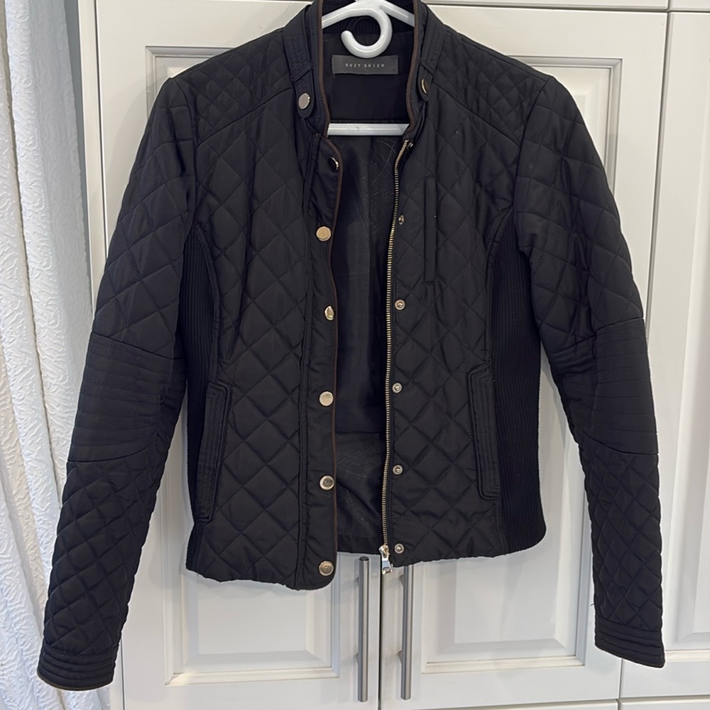 Suzy shier black jacket with gold color trim. Side pockets with zipper.